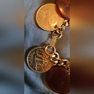 The eight dramatic Bakelite discs are mildly translucentGold Coin Charm Bracelet